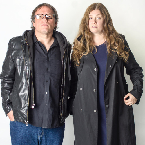 Two performers, a male and a female, posing against a white backdrop.
