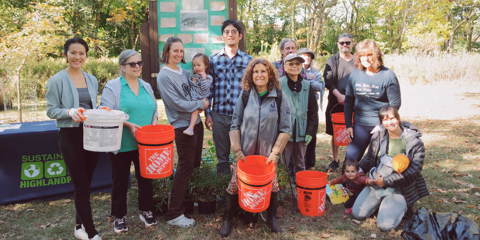 Sustainable Highland Park cleanup with volunteers wearing gloves and holding buckets.