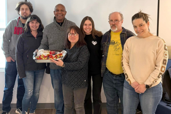 Attendees at a no-waste cooking workshop pose and show off a meal.