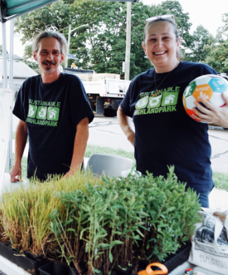 Two volunteers staffing a native plant giveaway.